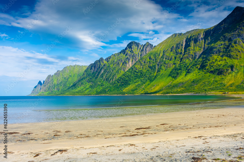 The crystal clear water of the Ersfjordstranda beach in Senja Island, Norway The crystal clear water of the Ersfjordstranda beach in Senja Island, Norway