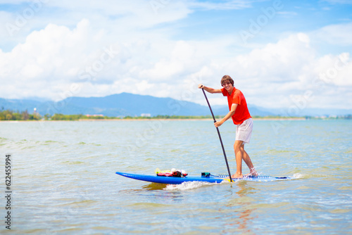 Man on stand up paddle. Water and beach sport © famveldman