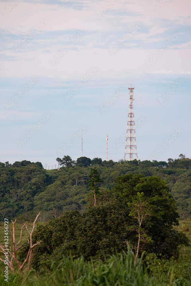 Metal telecommunication tower on top of a mountain