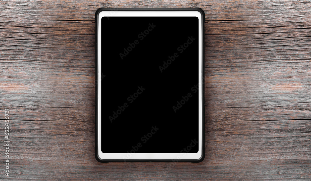 Tablet pc on old wood background. White digital tablet on a wooden table Tablet pc on old wood background. White digital tablet on a wooden table
