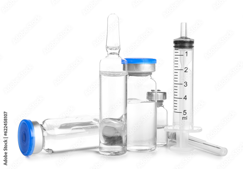 Medical ampules with syringe on white background Medical ampules with syringe on white background