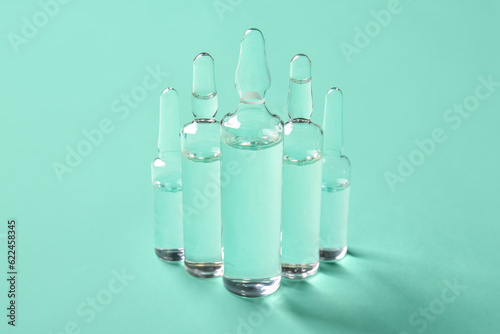 Medical ampules on green ba...