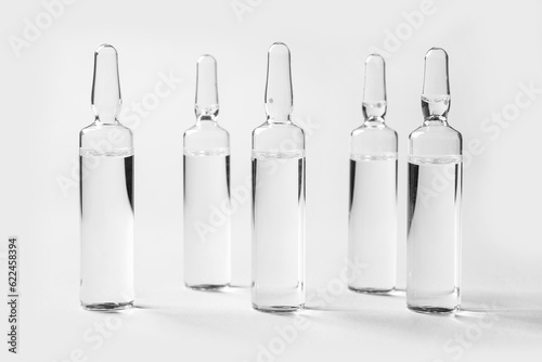 Medical ampules on light ba...