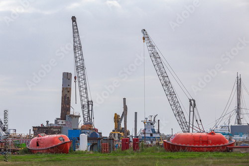 Cranes, lifeboats, life rafts, at an old deserted port in Luisiana photo