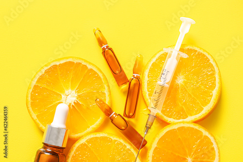 Canvastavla Ampoules with vitamin C, syringe, bottle of essential oil and orange slices on y