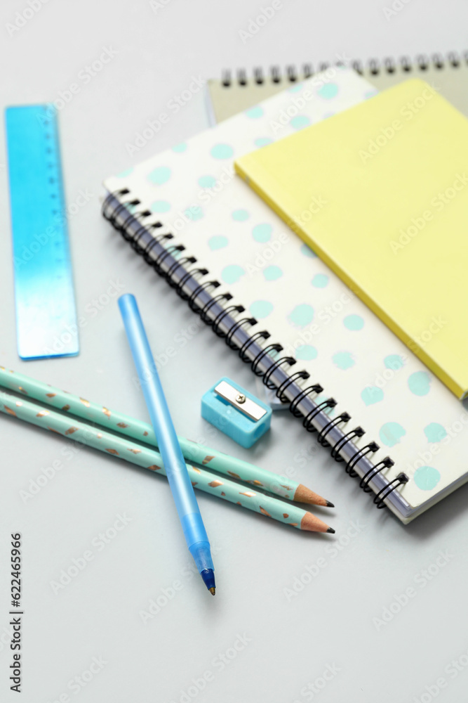Notebooks and school stationery on grey background Notebooks and school stationery on grey background