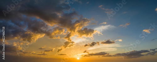 Colorful evening landscape with soft pastel coloured cloudscape on watercolor tinted sunset sky. Abstract nature background