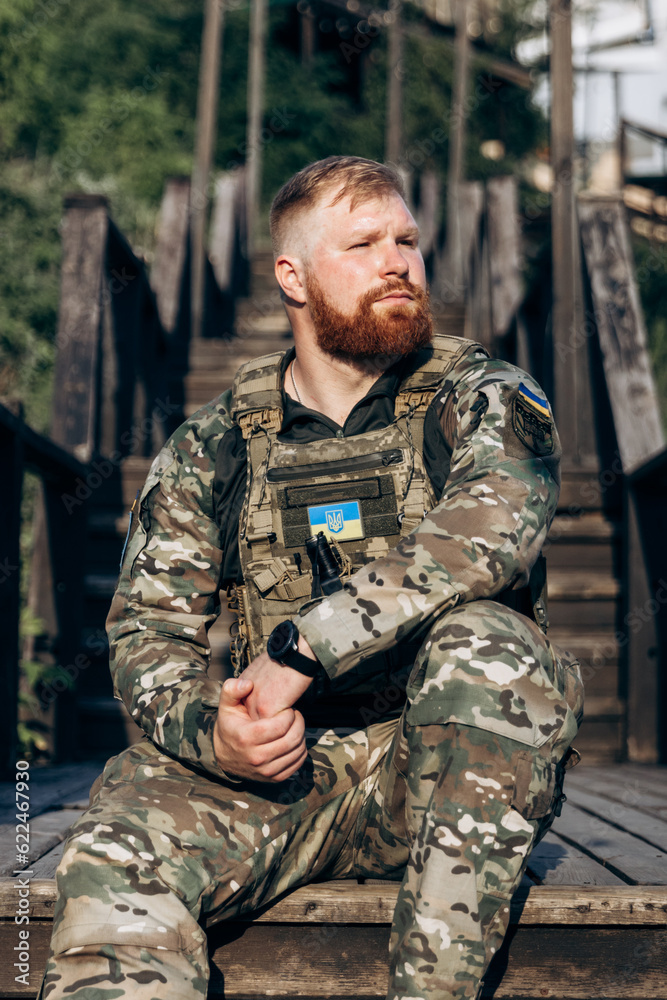Portrait of Ukrainian soldier in uniform on the street