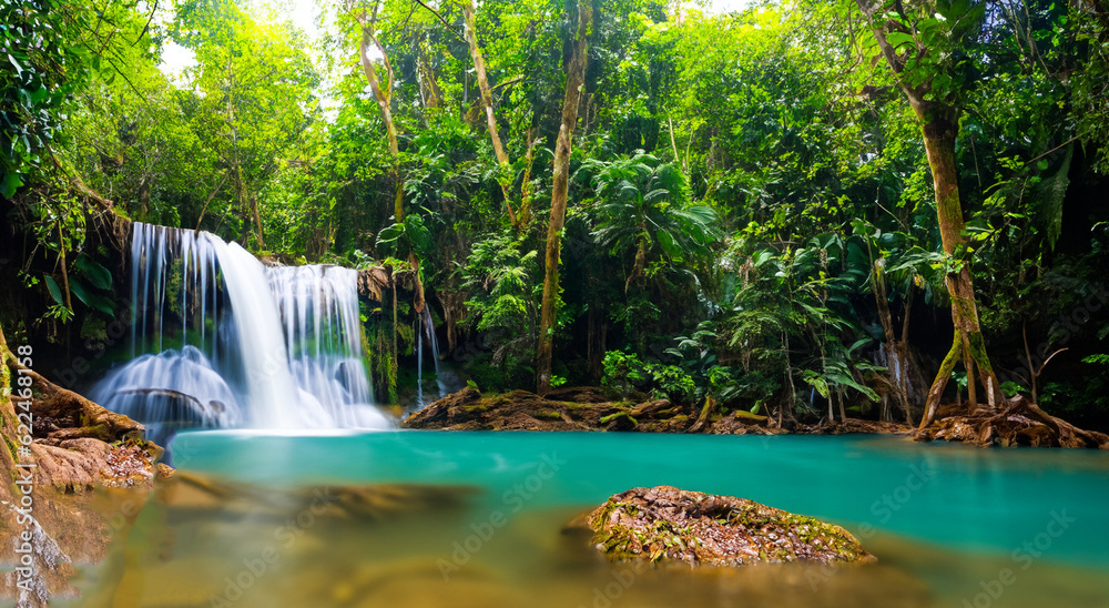 Naklejka premium beautiful waterfall falling on a river in a forest
