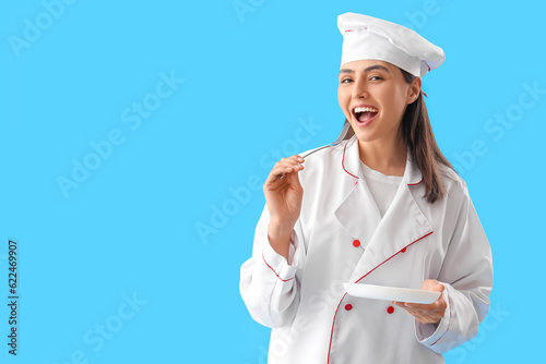Female chef with fork and p...