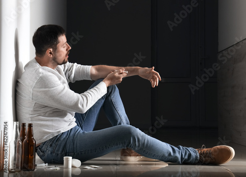 Male drug addict making inj...