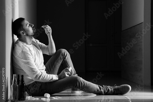 Male drug addict taking pil...