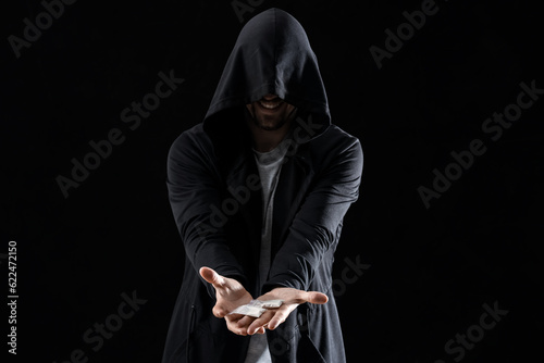 Male junkie with drugs on b...