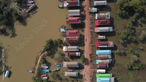 A Village with Riverside Houses and Dirt Road. Cambodia, floating village, Kampong Phluk, fisherman, 4k Drone footage