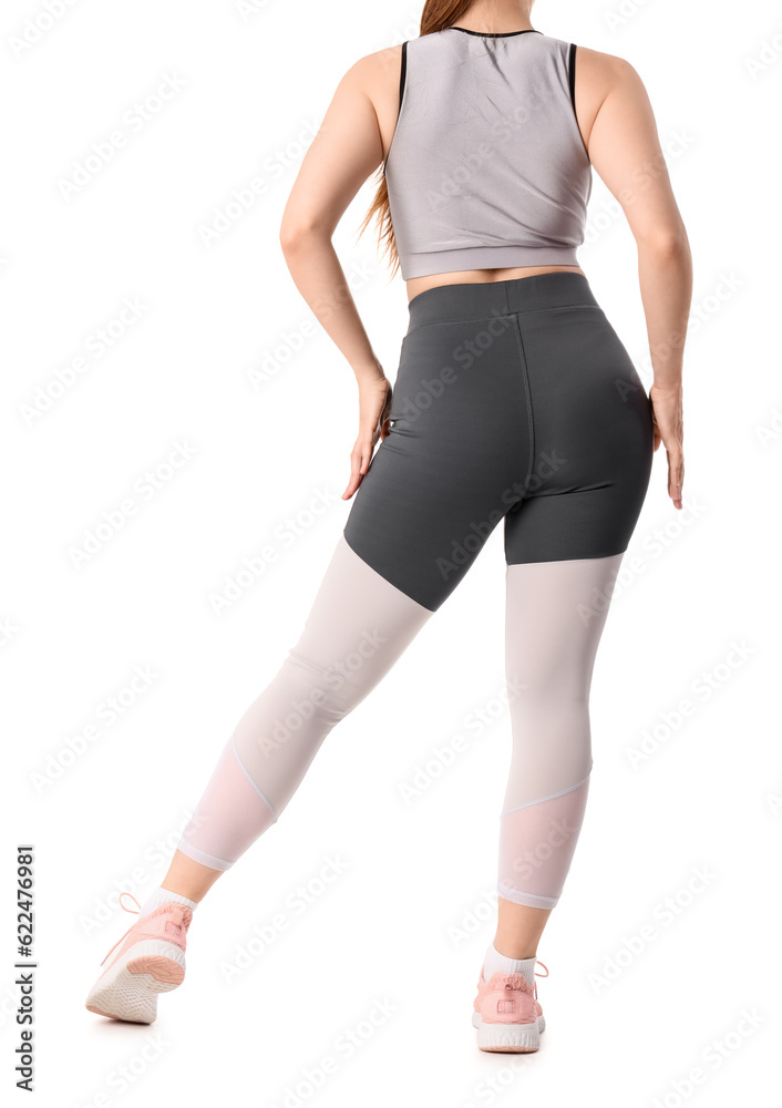 Young woman in sportswear on white background, back view