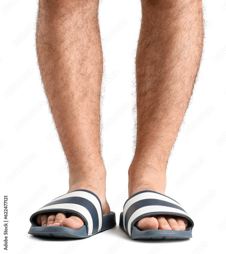 Male legs in flip-flops on white background