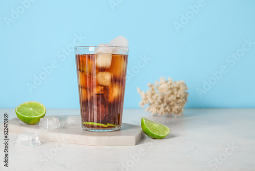 Canvas Print Board with glass of cold Cuba Libre cocktail and coral on white table