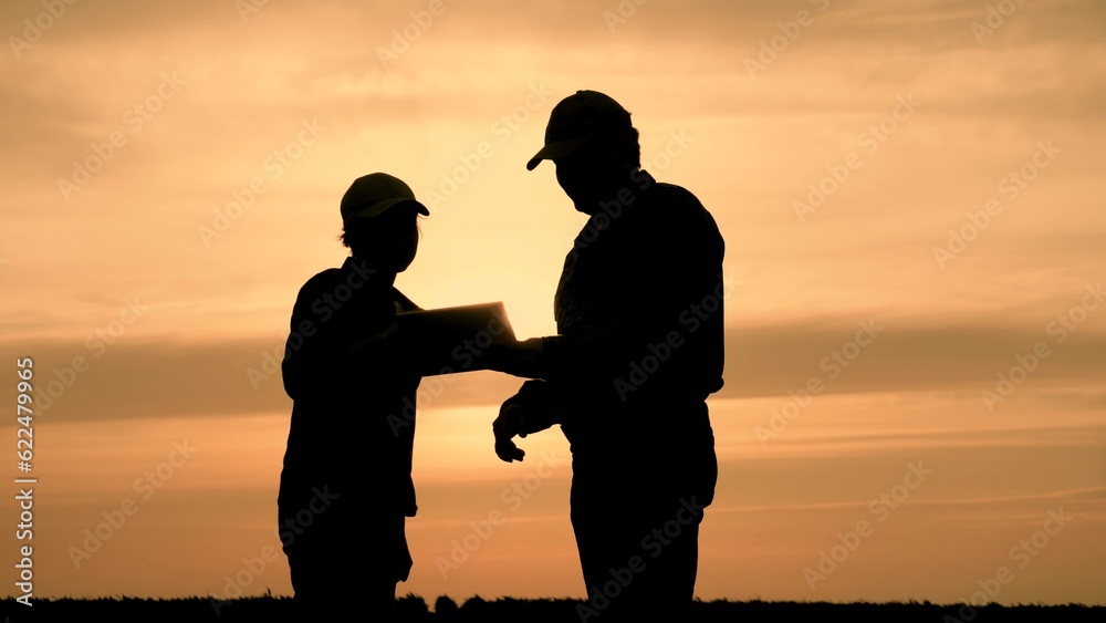 silhouette two farmers work tablet, farming, teamwork group people, contract handshake agreement, golden silhouette people inspecting farm holding contract agronomists showing sign silhouettes concept