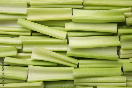 Fototapeta Naklejka Na Ścianę i Meble -  Fresh green cut celery as background, top view