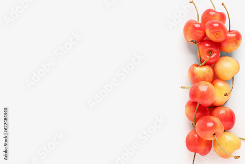 Many sweet yellow cherries on pink background
