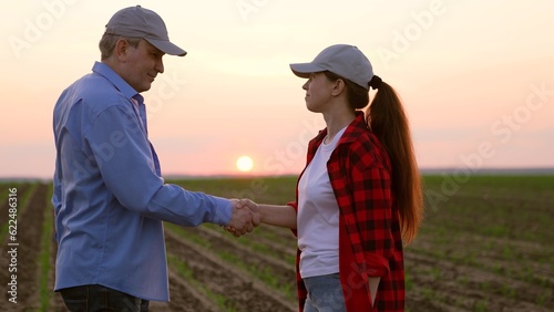 two farmers work field handshakemachinery road insurance wealth digital horizon slow pc cereal view garden labor sky worker inspect  corporate sunset  work tablet agriculture  hand sun farming farm