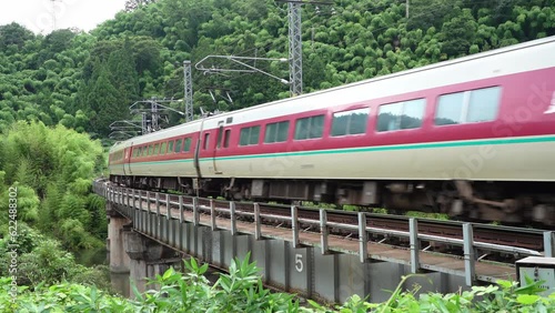 
Tottori, Japan - July 9, 2023: A limited express train running on a bridge between Kurosaka station and Neu station of Hakubi Line in Japan
 photo