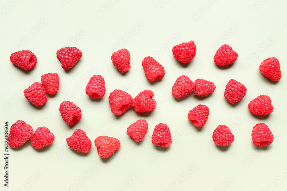 Many fresh raspberries on light green background Many fresh raspberries on light green background