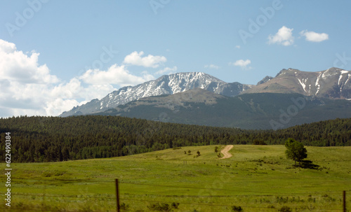 Landscape with snowy mountains in the background.