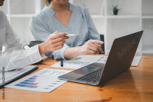 Asian business adviser meeting to analyze and discuss the situation on the financial report in the meeting room, Financial advisor and accounting concept