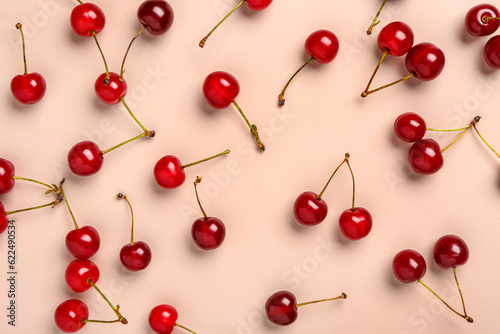 Red sweet cherries on pink background