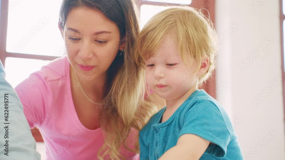 Caucasian family spend leisure time with baby boy in bedroom at house. Caucasian family spend leisure time with baby boy in bedroom at house.