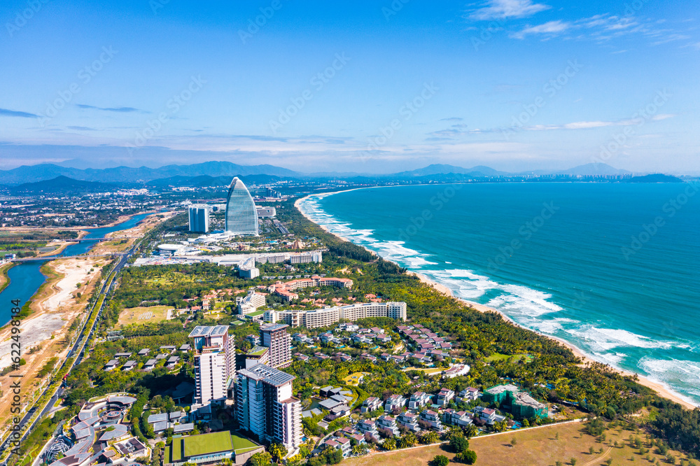 Aerial shots of the waves, coconut groves and cityscape along the coastline of Haitang Bay in Sanya