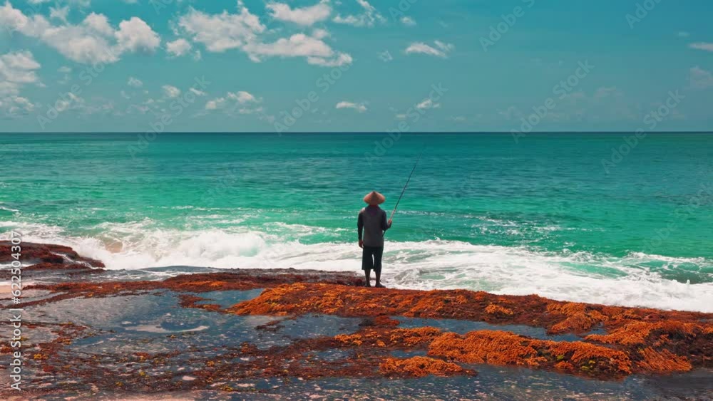 Beautiful coastline tropical beach with crystal clear azure ocean water and silhouette fisherman on nature background 4K Beautiful coastline tropical beach with crystal clear azure ocean water and silhouette fisherman on nature background 4K