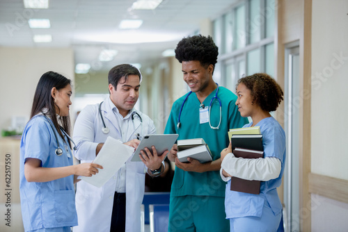 Teacher doctor man and group medical student standing looking work in tablet. education and learning medical concept. nurse students study from professional.