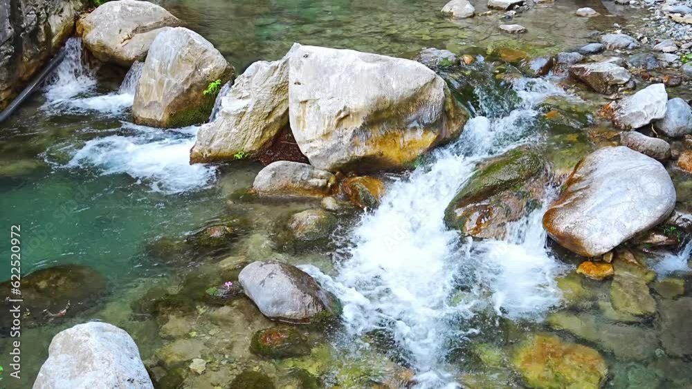Fast flowing water in Sapadere canyon with rocks and stones in the Taurus mountains near Alanya, Turkey