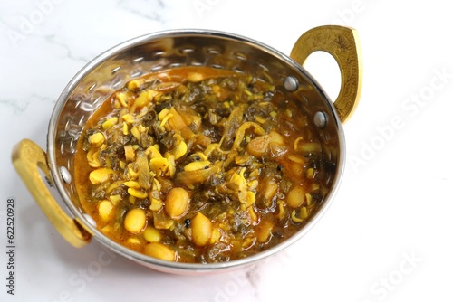 Alucha fatfate or alu wal chi patal bhaji is a traditional, authentic Maharashtrian dish. colocasia leaves and lima beans curry. It has a sweet and sour taste. Valachi bhaji. Fadfade. Monsoon recipes. photo