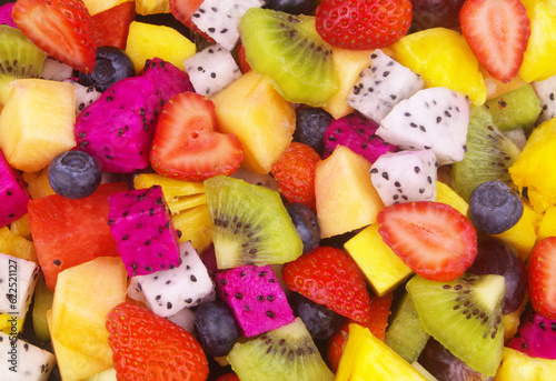 Fruit salad background. Many sliced fresh fruits close up.