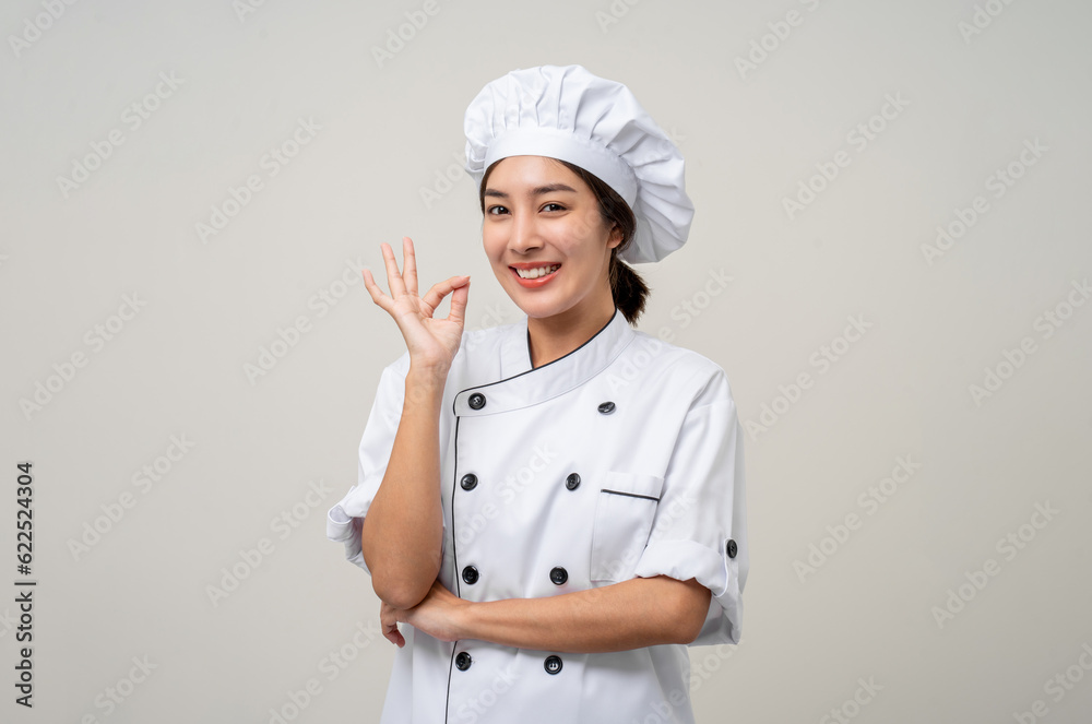 Young beautiful asian woman chef in uniform posting okay taste delight delicious hand gesture on isolated background. Cooking woman Occupation chef or baker People in kitchen restaurant and hotel. Young beautiful asian woman chef in uniform posting okay taste delight delicious hand gesture on isolated background. Cooking woman Occupation chef or baker People in kitchen restaurant and hotel.