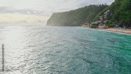 Tropical Island Bali Indonesia drone aerial shot birds eye view landscape nature coastline shore tourist travel Melasti beach sea sunset.