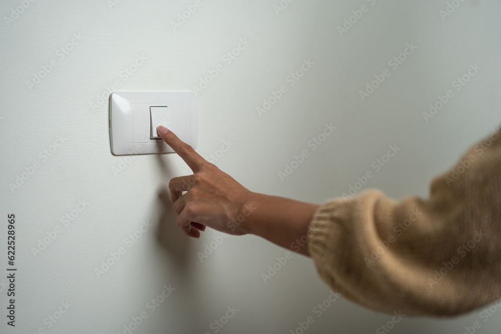 Earth Hour Close up woman finger turn off or on the light to saving ...