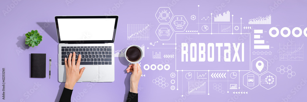 Robotaxi theme with person using a laptop computer Robotaxi theme with person using a laptop computer