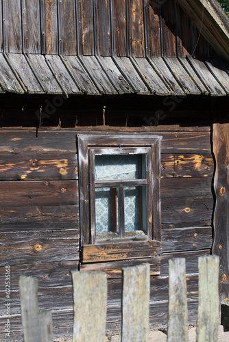 Window in an old wooden house. Log house.