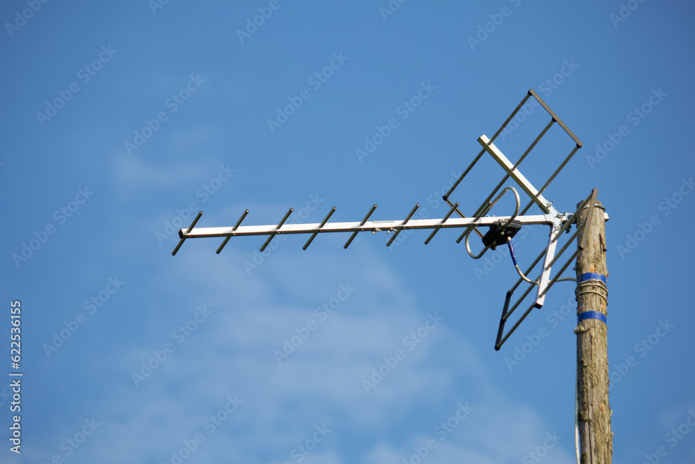 Homemade television antenna against the blue sky. Attached to a pole. Homemade television antenna against the blue sky. Attached to a pole.