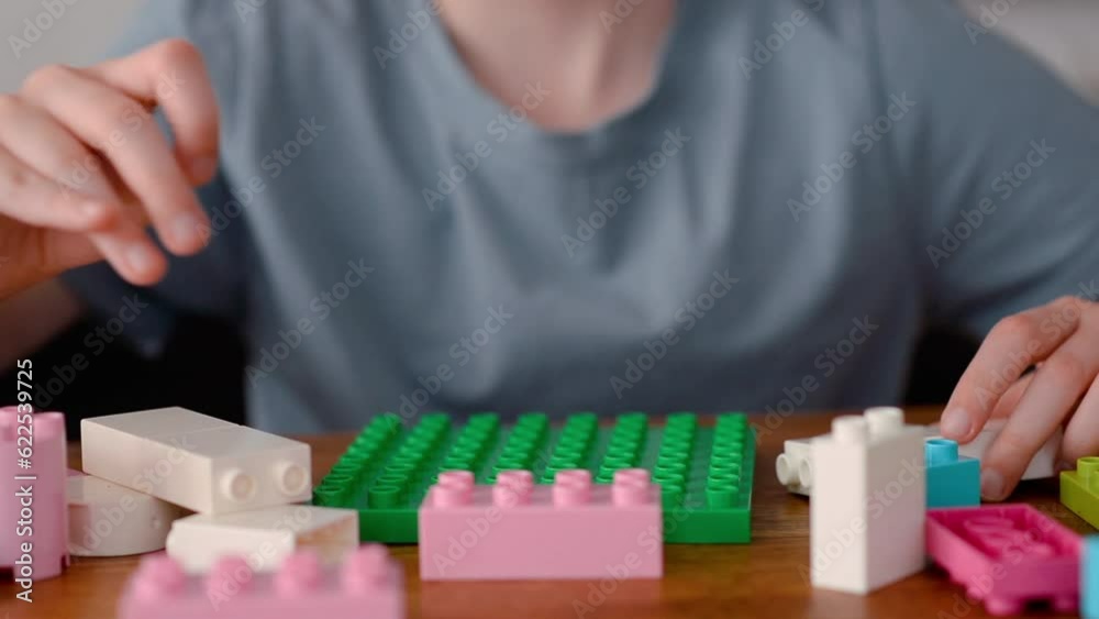 The child spends his free time playing constructor games The child spends his free time playing constructor games