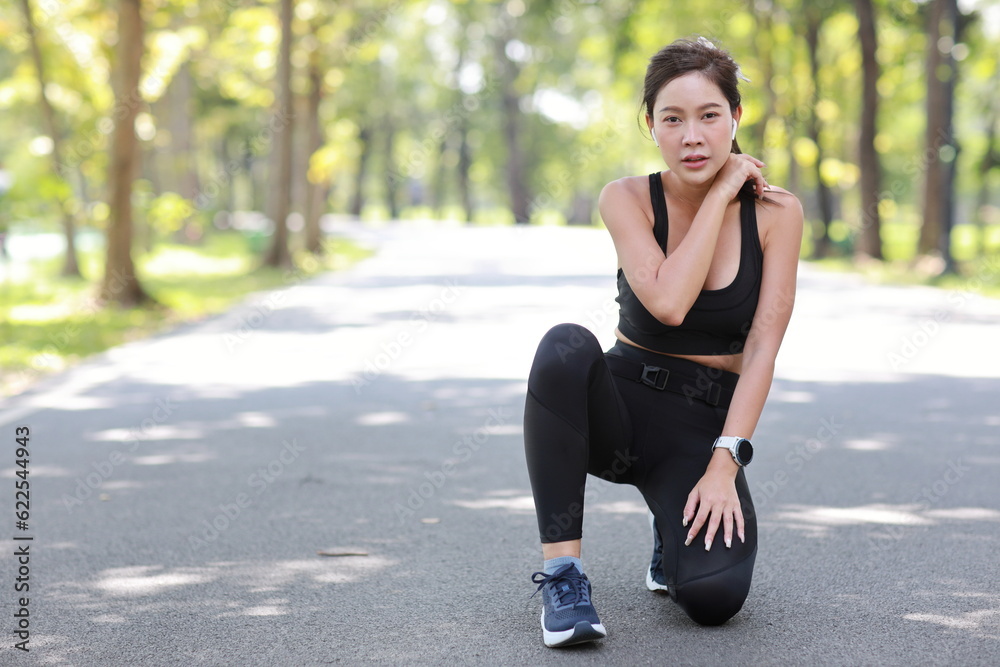 Portrait of young asian sportswoman sitting and suffering from chest pain or heart attack from morning excercise accident. Beautiful athlete painful woman waiting for help under the tree in the park Portrait of young asian sportswoman sitting and suffering from chest pain or heart attack from morning excercise accident. Beautiful athlete painful woman waiting for help under the tree in the park
