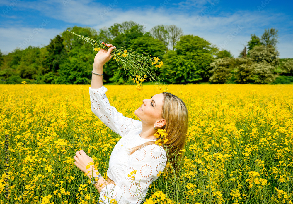 Portrait of a blond young woman in a field full of yellow flowers. Rapeseed field. Zest for life, happiness, contentment.
Portrait of a blond young woman in a field full of yellow flowers. Rapeseed field. Zest for life, happiness, contentment.