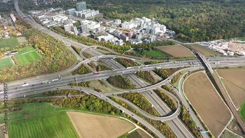 Aerial drone view of a multi-level highway intersection with moving cars near the city of Stuttgart, Germany. Trucks move along a multi-level road junction. The concept of the urban. photo