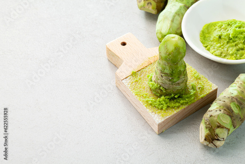 grated fresh wasabi and wasabi roots on a kitchen slab. photo