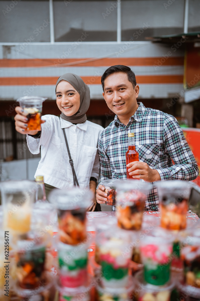 a pretty girl in a veil and a man sells mix fruit beverage and juice in the street during ramadan a pretty girl in a veil and a man sells mix fruit beverage and juice in the street during ramadan