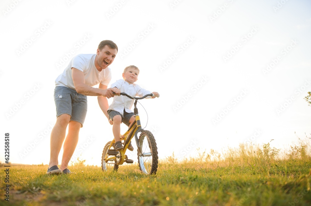 father's day. Dad and son playing together outdoors on a summer. Happy family, father, son at sunset.